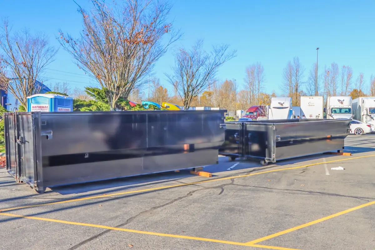 Professional dumpster rental service with roll-off container on residential driveway in Florence-Graham